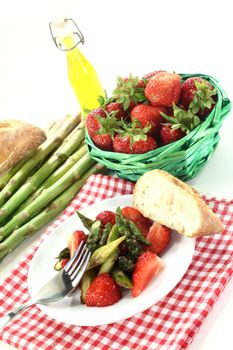 a plate of asparagus strawberry salad with roasted green asparagus