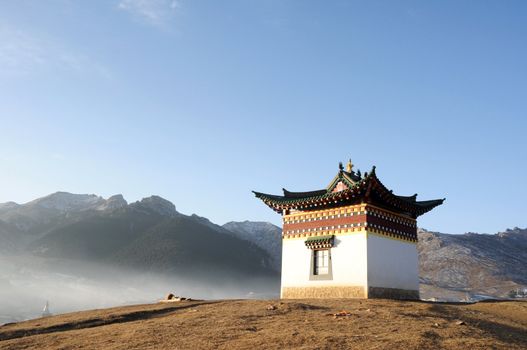 Golden historic Tibetan shrine on a hill
