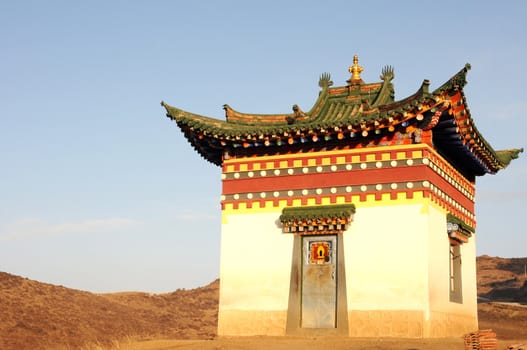 Golden historic Tibetan shrine on a hill