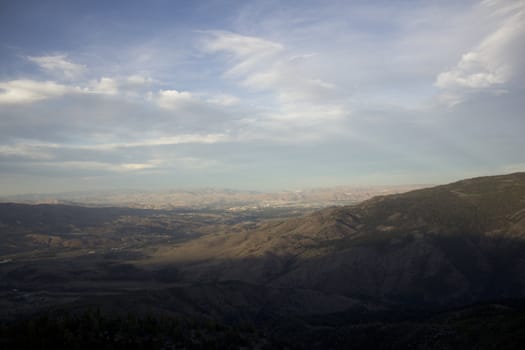 Clouds at dusk in the mountains. dark mountains and a bright blue sky.