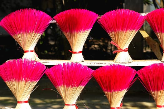 Red incense or joss sticks for buddhist prayers in Vietnam 