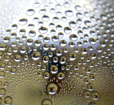 Water drops on the curve transparent surface. Defocused image.                               