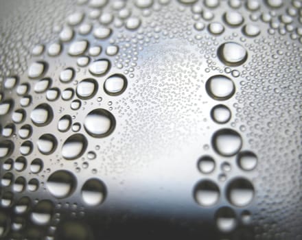 Water drops on the curve transparent surface. Shallow DOF.                                 