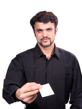 A young Indian guy giving his new business card, focus on the hand and card. Card left blank for designers editing.