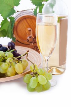 White wine bottle, glass and cask with grapes over white