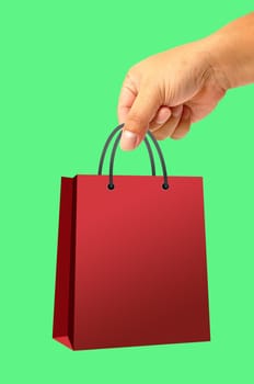 Shopping bag in hand isolated on green background