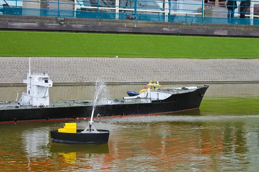 Children's amusement at Madurodam. Netherlands, Den Haag. Extinguishing the burning ship