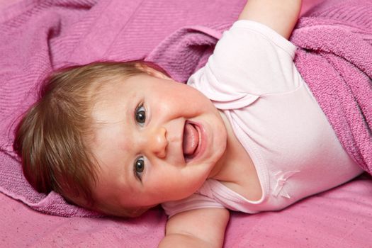 An adorable, laughing baby looking at camera