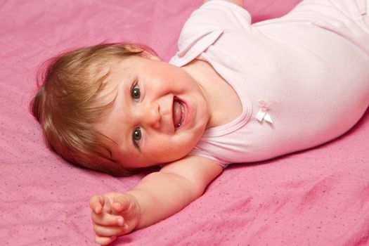 An adorable, laughing baby looking at camera