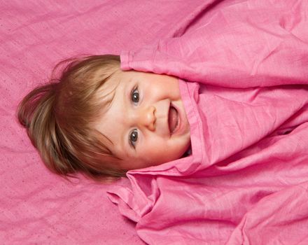 An adorable, laughing baby looking at camera