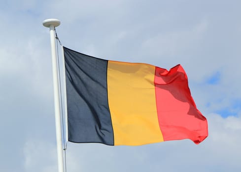 Flag of Belgium against cloudy sky