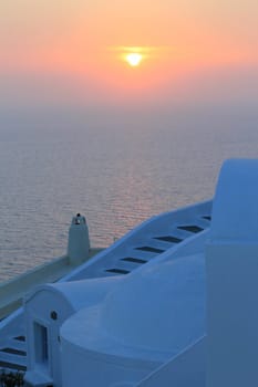 Beautiful sunset behind white stairs at Oia village, Santorini, Greece