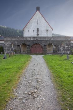 Picture of a graveyard buildning with a pathway leading to it