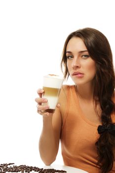 beautiful woman with latte macchiato coffee bites on her lips on white background