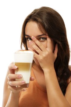 young woman with latte macchiato coffee hiding her face with her hand on white background