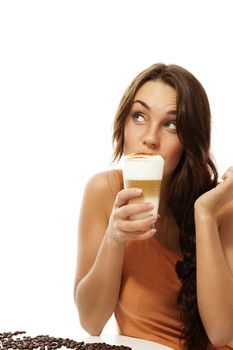 young woman drinking latte macchiato coffee looking up on white background