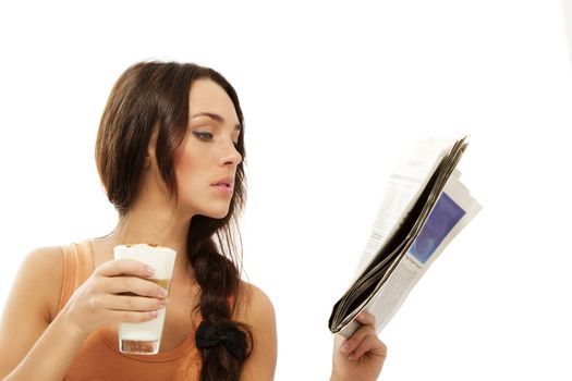 young woman reading newspaper holding latte macchiato coffee on white background