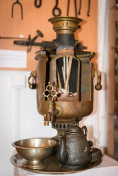 Traditional samovar with internal contents and teapot, selective focus on the front spout