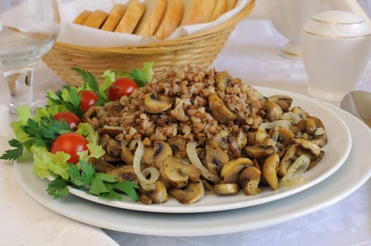 Buckwheat porridge with mushrooms and onions on the dining table