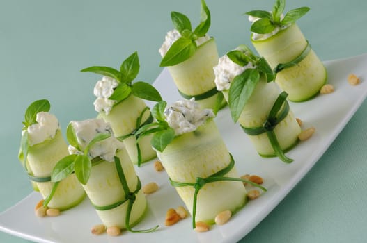 Rolls of zucchini stuffed with ricotta and basil and pine nuts