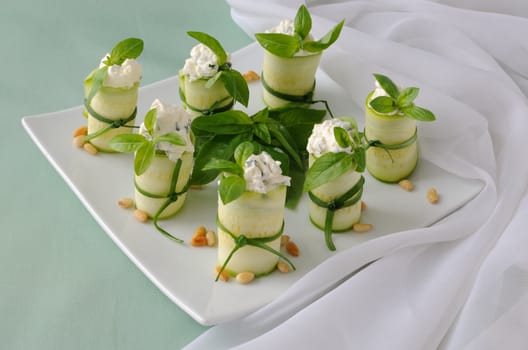 Rolls of zucchini stuffed with ricotta and basil and pine nuts