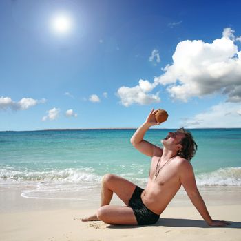 on vacation at the beach posing with coconut