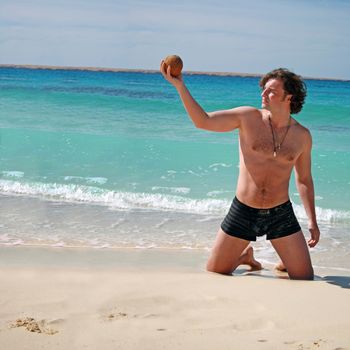 on vacation at the beach posing with coconut