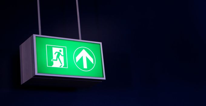 Emergency exit sign in modern offices inside an industrial plant