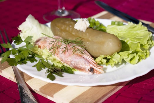 Easy snack from seafood and a marinaded cucumber with a sharp horse-radish