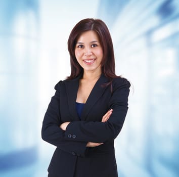 Mixed race Mid adult Asian woman standing on office background