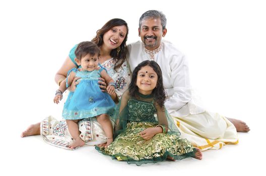 Happy Indian family sitting on white background