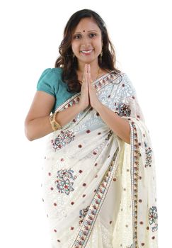 Mid Adult Indian woman in a greeting pose, isolated white background