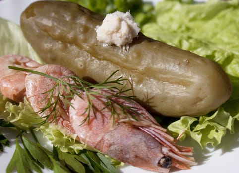 Easy snack from seafood and a marinaded cucumber with a sharp horse-radish