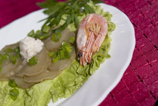 Easy snack from seafood and a marinaded cucumber with a sharp horse-radish