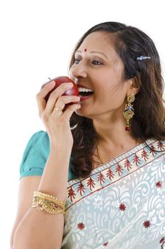 Healthy Indian woman eating red apple, isolated on white background