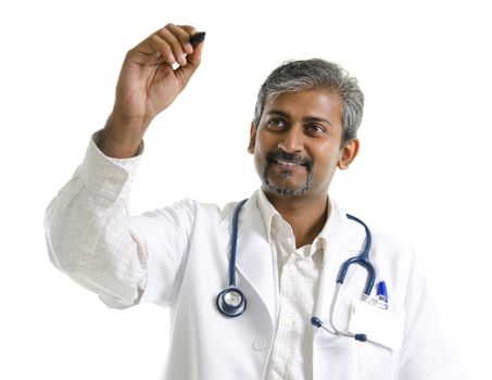 Indian mature male doctor drawing / sketching on blank space