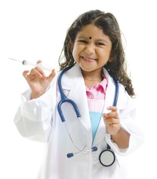 Cute little Indian future doctor holding syringe with cheerful smile isolated on white background