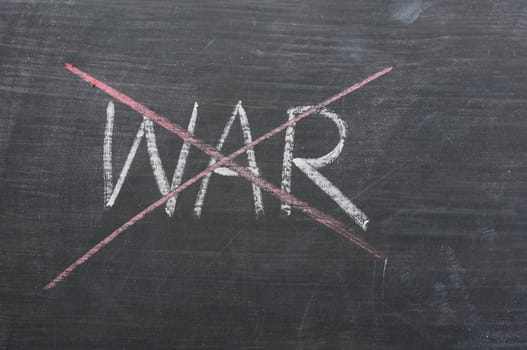 War - word crossed out with red chalk on a smudged blackboard