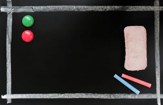 Blackboard background with a chalk frame and eraser, colorful chalk