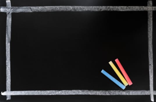 Blackboard background with a chalk frame and colorful chalk