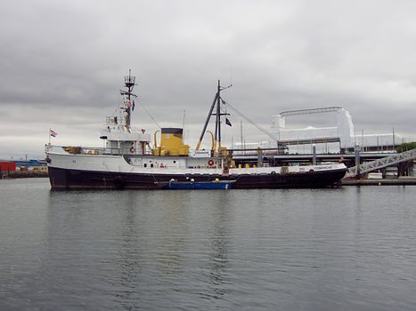 A photograph of a World War II era, Sotoyomo-class auxiliary ocean tugboat detailing its structure and design.  This particular tow boat was commissioned in 1944 and was known as ATA-202 Wampanoag during its naval service.  In 1959, it was renamed the Comanche WATA 202 and later WMEC 202 and used by the United States Coast Guard for law enforcement and marine distress assistance until 1980.