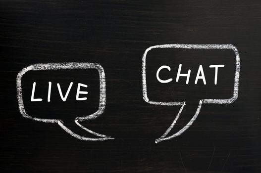 Two speech bubbles for Live Chat drawn with chalk on a blackboard