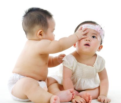 Two Asian babies sitting on white background