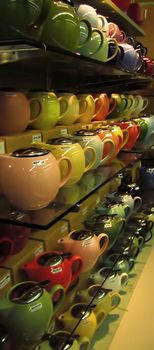 A photograph of various teapots for sale in a grocery store.