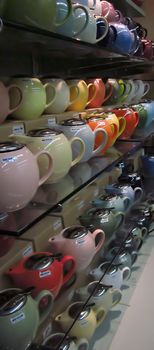 A photograph of various teapots for sale in a grocery store.