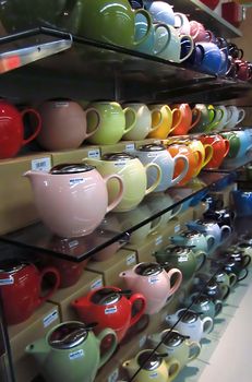 A photograph of various teapots for sale in a grocery store.