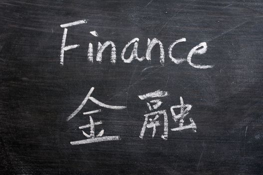 Finance - word written on a smudged blackboard with a Chinese translation