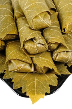 Dolma on a black plate. Isolated on white background.