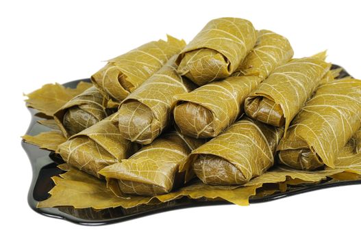 Dolma on a black plate. Isolated on white background.