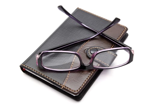 notebook and glasses isolated on white background 
